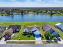 An aerial view of a single-Gathering home with a meticulously maintained yard on a picturesque lake at 12137 Dickenson Ln, Orlando, FL 32821