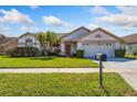 A charming, single-story house features a lush green lawn and a manicured shrubbery at 12137 Dickenson Ln, Orlando, FL 32821