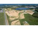 An aerial view of the community showing planned home sites and a peaceful lake in the background at 16765 Muskgrass Dr, Winter Garden, FL 34787