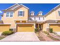 Charming townhome featuring a two-car garage and well-maintained landscaping at 17437 Promenade Dr, Clermont, FL 34711