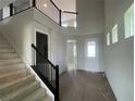 Elegant foyer showcases soaring ceilings, wood floors, and an open staircase at 17505 Glossy Pomelo Way, Winter Garden, FL 34787