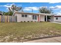 Inviting single-story residence with a manicured lawn and bright, welcoming facade at 1810 Kingsland Ave, Orlando, FL 32808