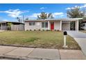 Cozy single-story home boasts a vibrant red front door and well-maintained lawn at 1810 Kingsland Ave, Orlando, FL 32808