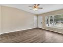 Bright living room featuring wood floors, a ceiling fan, and a sunlit window at 1810 Kingsland Ave, Orlando, FL 32808