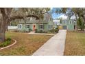 Inviting exterior view of a charming single-Gathering home with a detached garage and long driveway at 201 W 16Th St, Sanford, FL 32771