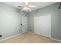 Cozy bedroom featuring carpeted floors, a ceiling fan, and a closet for ample storage at 2700 Child St, Ocoee, FL 34761