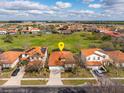 Aerial view of a neighborhood highlighting a house with orange tile roof and a yellow pin marker at 304 Summer Place Loop, Clermont, FL 34714