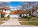 Charming single Gathering home with clay tile roof, well manicured lawn, and two car garage at 304 Summer Place Loop, Clermont, FL 34714