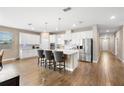 Bright, modern kitchen with white cabinetry, stainless steel appliances, and a center island with seating at 3136 Winesap Way, Winter Garden, FL 34787