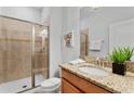 Cozy bathroom with a walk-in shower, granite vanity, and modern fixtures at 3197 Pequod Pl, Kissimmee, FL 34746