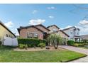 Charming single-Gathering home with manicured lawn and garden, complimented by a paver driveway at 3430 Halsway Dr, Orlando, FL 32824