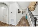 Inviting home foyer with hardwood floors, stone accent wall and iron staircase railing at 3430 Halsway Dr, Orlando, FL 32824