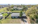 Aerial view of the property with a large backyard and above-ground pool in a neighborhood setting at 395 Bearcreek Dr, Bartow, FL 33830