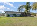 Cozy single-Gathering house featuring a screened-in porch and well-maintained front yard at 395 Bearcreek Dr, Bartow, FL 33830