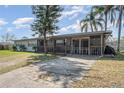 Attractive single-story house with a screened-in porch and a concrete driveway at 395 Bearcreek Dr, Bartow, FL 33830