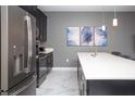 Modern kitchen featuring stainless steel appliances, sleek cabinetry, and a bright white countertop at 432 Ocean Course Ave, Davenport, FL 33896