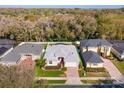 Expansive aerial view of a lovely neighborhood, showcasing lush greenery and neatly arranged homes at 4963 Rock Rose Loop, Sanford, FL 32771