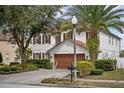 Charming two-story home with lush landscaping and a two-car garage at 5314 Adair Oak Dr, Orlando, FL 32829