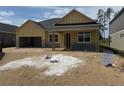 New construction home with attached garage and covered front porch at 804 Pointe Emerson Blvd, Apopka, FL 32703