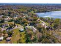 Aerial view of the property showcasing its location near a lake and lush greenery at 1518 Fabian Ave, Orlando, FL 32807