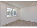 Well-lit bedroom featuring wood-look tile floors and a large window with trim at 1518 Fabian Ave, Orlando, FL 32807