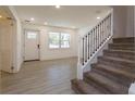 Bright foyer with tile flooring, staircase with iron railing, and front door at 1518 Fabian Ave, Orlando, FL 32807