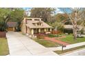 Beautiful home with a long driveway, lush greenery, and a detached garage at 1920 S Palmetto Ave, Sanford, FL 32771