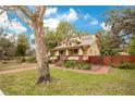 Landscaped front yard featuring a brick walkway, and a welcoming front porch at 1920 S Palmetto Ave, Sanford, FL 32771