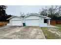 This home features a two-car garage and neutral paint with a wooden fence in the background at 218 Perth Ct # A, Winter Springs, FL 32708