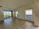 Bright living room with tile floors, and large sliding doors that provide lots of natural light at 2634 Rutledge Ct, Winter Haven, FL 33884