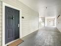 Hallway view of apartment door with hard surface floors and stairway access at 3175 Feltrim Pl # 304, Kissimmee, FL 34747