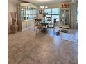 Cozy dining room with tile flooring, decorative cabinetry, and a glass-topped table at 3209 Casa Del Rey Ave, Kissimmee, FL 34746