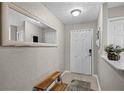 Light and bright entryway with a large mirror and bench seating at 3658 Caruso Pl, Oviedo, FL 32765