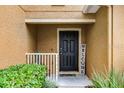 Front door with welcome sign and white railing at 3658 Caruso Pl, Oviedo, FL 32765