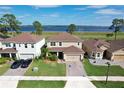 Aerial view of a home with well-kept lawn near a picturesque lake at 411 Lazio Cir, Debary, FL 32713