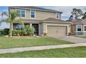 Beautiful two-story home showcasing lush landscaping and a convenient two-car garage at 411 Lazio Cir, Debary, FL 32713