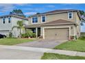 Attractive two-story home features well-maintained lawn and convenient two-car garage at 411 Lazio Cir, Debary, FL 32713