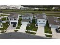 An aerial view of modern single-Gathering homes featuring well-manicured lawns and paved driveways at 5017 Blue Hammock Ct, Kissimmee, FL 34746