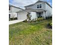 Charming two-story home featuring light blue siding, a well-manicured lawn, and a two-car garage at 5017 Blue Hammock Ct, Kissimmee, FL 34746