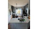 Well-lit kitchen featuring gray cabinets, stainless steel appliances and a small island at 719 Del Ray Dr, Kissimmee, FL 34758