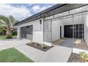 Stylish front entrance with a wrought iron gate and a modern black brick accent wall at 7531 Lodge Pole Trl, Winter Park, FL 32792