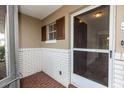 View of the covered entryway with brick accents and a storm door at 759 Swallow St, Deltona, FL 32725