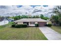 Charming single-story home with manicured lawn, neutral paint, and attached two-car garage at 759 Swallow St, Deltona, FL 32725