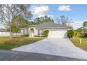 Beautiful single-story home featuring a well-manicured lawn and an attached two-car garage at 939 Van Loon Ct, Kissimmee, FL 34758