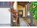 Inviting front entrance with a decorative glass door and manicured landscaping at 10 Trophy Ln, Kissimmee, FL 34759