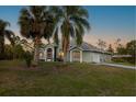 Inviting home exterior with mature palm trees and lush green lawn at 1045 S State Road 415, New Smyrna Beach, FL 32168