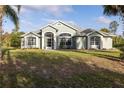 Beautiful home exterior featuring a well-maintained lawn and manicured landscaping at 1045 S State Road 415, New Smyrna Beach, FL 32168