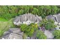 Overhead view of condo building with ample parking and mature trees at 13013 Mulberry Park Dr # 222, Orlando, FL 32821