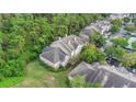 Aerial view of condo building next to lush woods at 13013 Mulberry Park Dr # 222, Orlando, FL 32821