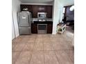 A kitchen featuring stainless steel appliances, dark cabinetry and tile flooring at 14218 Squirrel Run, Orlando, FL 32828